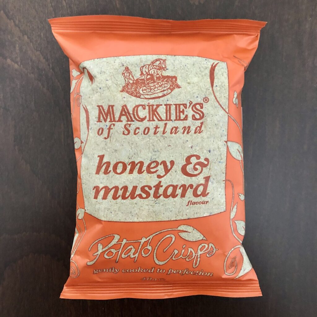 「Mackies（マッキーズ）　ポテトチップス　ハニー＆マスタード味」の袋の表面